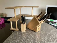 knives inserted into blocks on wood stand