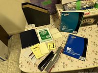 Overview of lot with notebooks, staplers, pads, file holder