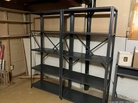 Two gray metal shelving racks side by side showing full structure
