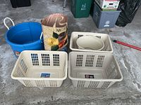 All three laundry baskets, blue tub, straw tote and straw hats grouped together