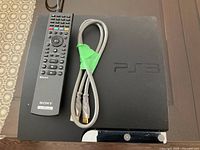 Top view of PS3 Slim with Sony remote and HDMI cable