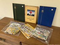 Overall lot: three albums, two bags of loose stamps, loose sheet