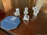 Three crystal animal figurines (cat, bear, duck) and one prism with Original Silver Crystal booklet