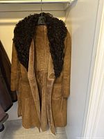Full view of tan suede long coat with faux shearling collar and belt