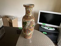 Full view of tall porcelain vase on table