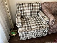 Front view of plaid woven bouclé armchair next to sofa
