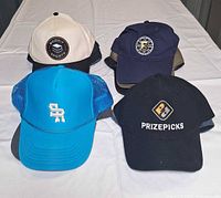 Four hats: Rookie Sports, Bruins, SR, PrizePicks