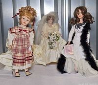 Three dolls side by side showing outfits and stands