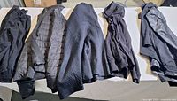 Five jackets laid flat showing variety