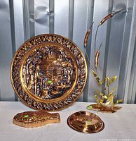 Group shot of four brass/copper decor pieces