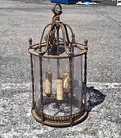 Full view of brass lantern on ground