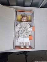 Doll secured inside original box with packaging