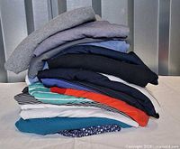 Stack of folded collared shirts showing variety of colors