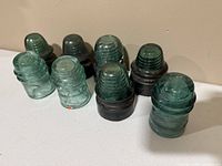 Group of all eight glass insulators upright on surface