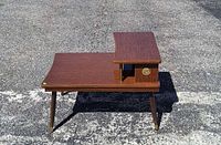 Full view of the two-tier end table on pavement
