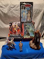 Group shot showing all boxed and loose figures on blue cloth