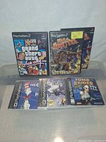 Two PS2 games front covers and five PS1 jewel cases front covers displayed