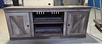 Front view of entire TV stand showing doors and shelves