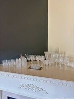Entire assortment of crystal glassware displayed on mantel