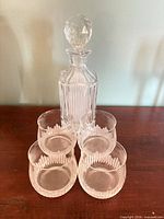 front view of decanter with stopper and four glasses