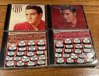 Four CD jewel cases: two Elvis Presley titles, two 50s/60s compilation volumes