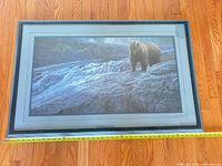 Full view of framed print with tape measure for scale
