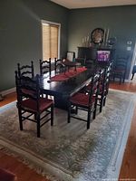 Full view of table with 8 chairs on rug