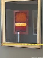 First framed artwork with tape measure across width