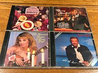 Front view of four CD cases showing titles and cover art