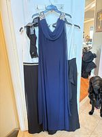 Front view of navy floor-length beaded gown on hanger