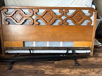 Full view of wooden headboard attached to metal frame