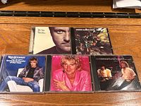 Five CD jewel cases laid out showing front artwork