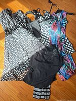 All six garments laid flat on floor showing prints and styles