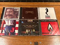 Front view of six CD cases displaying cover art and titles