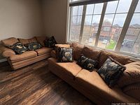 Sofa and loveseat together, showing overall style and pillows