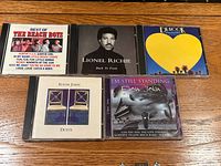 All five CD jewel cases front covers visible together