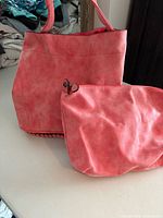 Handbag and matching makeup bag side by side
