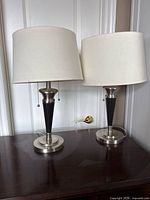 Front view of both matching table lamps showing bases, bodies and shades