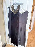 Full view of both dresses hanging on door