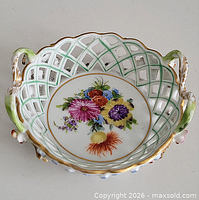 Top view showing lattice pattern, floral painting, and handles