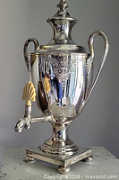 Full front view of silver plated tea urn
