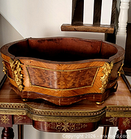 Overall frontal view of walnut burl and gilt bronze mounted planter