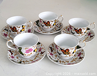 Five porcelain butterfly teacups each on matching saucer