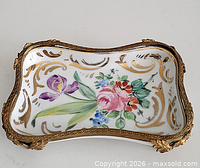Top view showing floral painting and ormolu rim