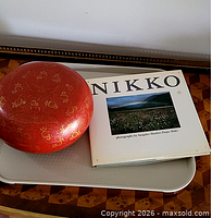 Red lacquered covered bowl and Nikko book on tray