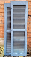 Front view of both shutters standing against wall