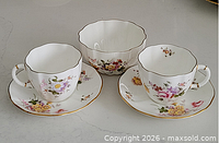 Two teacups, two saucers, one bowl displayed