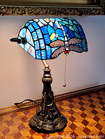 Full view of lamp showing stained glass shade and metal base