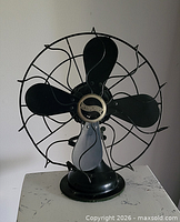 Front view of vintage Westinghouse fan showing blades, guard and base