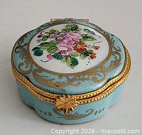 Top view of trinket box showing floral design and brass rim